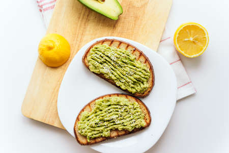 toasted bread with avocado paste. Avocado mixed with lemon juice is spread on bread. toast with...