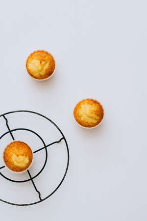 Homemade orange muffins on a white background. Minimalism
