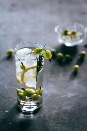 Refreshing lemonade with ice, from gooseberry, lemon, rosemary and sugar syrup