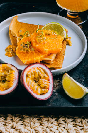 Crepes Or Thin Pancakes With Delicious passion fruit and lime. Summer tropical concept.の写真素材