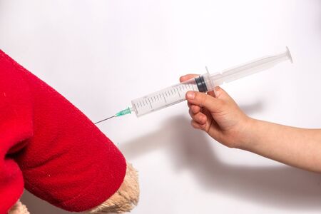 Cute little girl in medical mask and white t-shirt playing doctorの写真素材