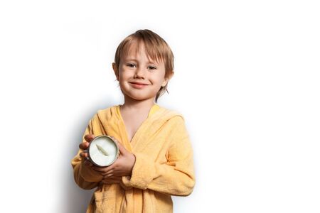 Cute girl in a yellow bathrobe with eye patchesの写真素材