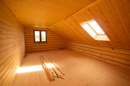 Empty room with rustic timber ceiling and skylights