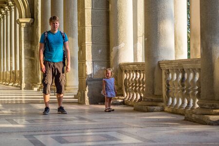 Little girl with her father among greeneryの写真素材