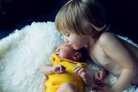Older sister with her newborn brother. Sister love.の写真素材