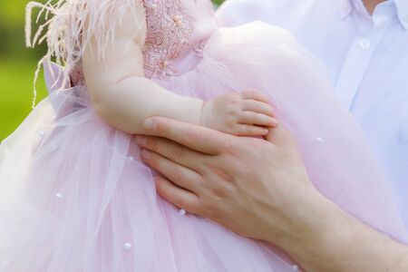 Father holding his dauthers hand cute little girlの写真素材