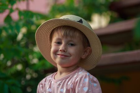 Closeup Portrait of fashionable cute little girl sitting on steps outdoorsの写真素材