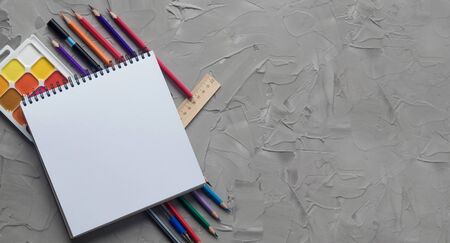 School supplies center composition on grey .concrete backgroundの写真素材