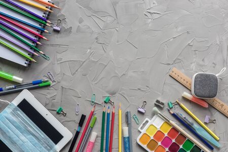 School supplies border on grey .concrete background.の写真素材