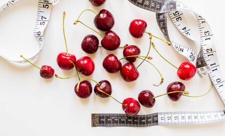 bunch of ripe cherry berries on white background. Burgundy, healthy,の写真素材