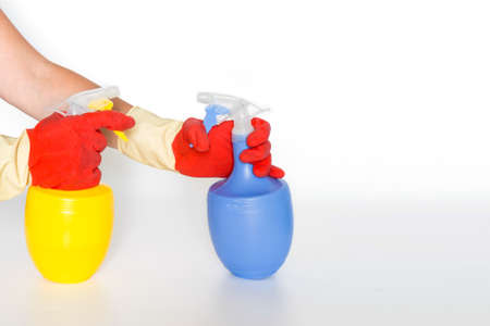 Hand with Plastic bottles with chemicals for home cleaning