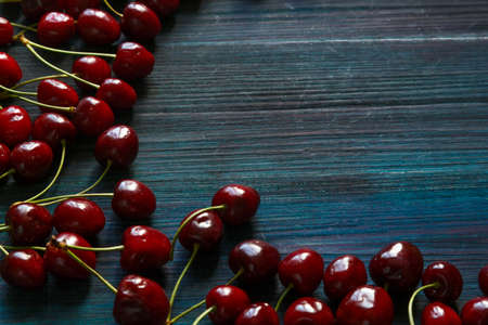 Fresh cherry on the table on wooden blue background.の写真素材