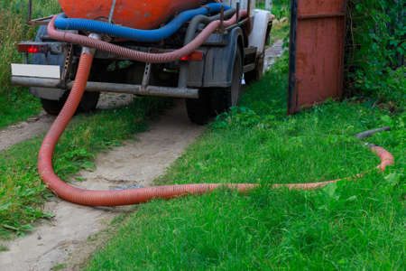 A Sewage truck working in village environmentの写真素材
