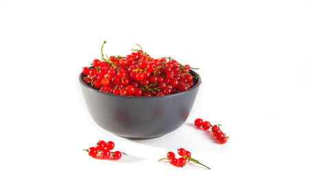 Ripe tasty red currants in a gray bowl on white background.