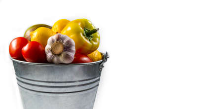 Aluminum bucket with assortment of fresh vegetables on white background.の写真素材