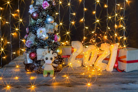 Christmas background with crocheted toy bull and numbers 2021. High quality photo