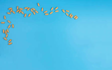 Herbal pills with healthy medical plant. Healthy supplement on blue background.