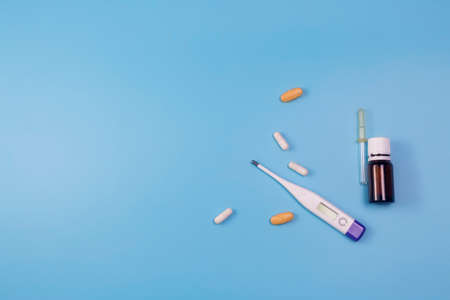 Medication for sore throat on blue background