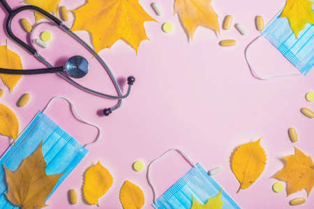 Autumn fallen leaves and medical masks and medicines on black background.の写真素材