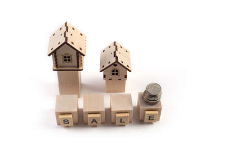 .Real Estate Sale Small Toy Wooden Houses and Sale Lettering.