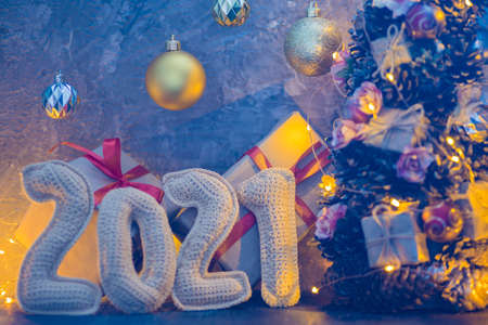 New year's holiday composition with crochet numbers 2021 gift box, and garland decor and christmas...
