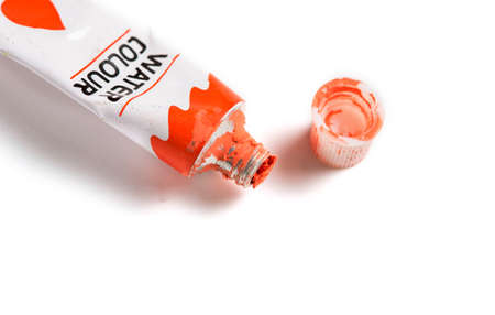Dried red watercolor paint in a tube isolated on white background.の写真素材