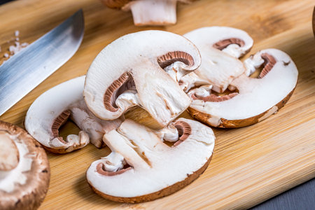 Close-up of a slice of edible mushroom Royal champignons on a cutting board. Delicious and healthy food concept.の写真素材