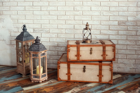 Decorative vintage suitcases and lamps against the background of a textured wall, a stylized photo zone.の写真素材