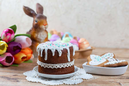 Easter still life with cake, homemade cookies, decorative figurine of rabbit