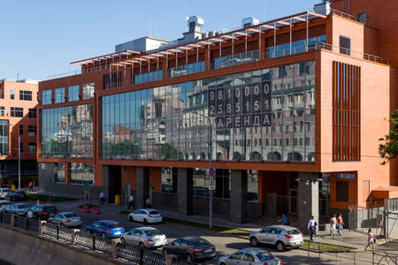 Moscow, Russia - May 21, 2014: View of city buildings made of glass, concrete and metal and cars on the river embankmentのeditorial素材