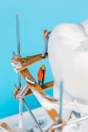 Moscow, Russia - 9th Matra 2021: A model of a human tooth and an art installation of small figures...