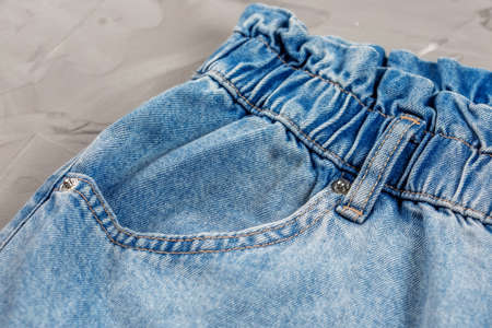 Close-up of blue jeans pocket showing fabric texture and stitching.の写真素材