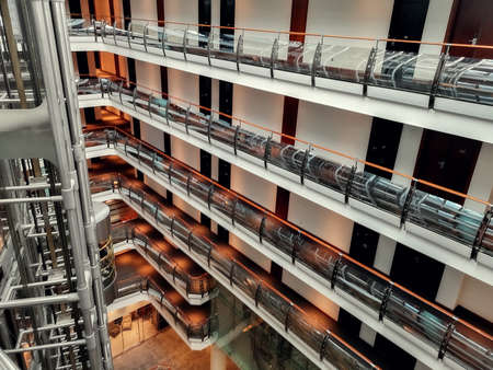 Moscow, Russia - February 14, 2021: Hall of a luxury hotel in Moscow, floors, corridors and transparent elevators are visible.のeditorial素材