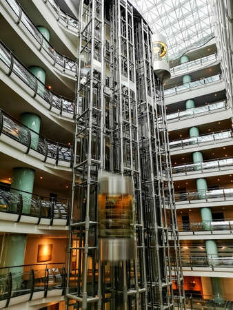 Moscow, Russia - February 14, 2021: Hall of a luxury hotel in Moscow, floors, corridors and transparent elevators are visible.のeditorial素材