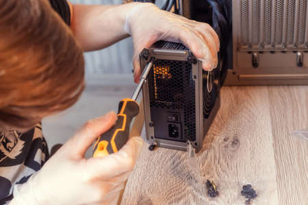 Installing Power Supply Unit into the desktop PC system unit. Computer components. PC assemble