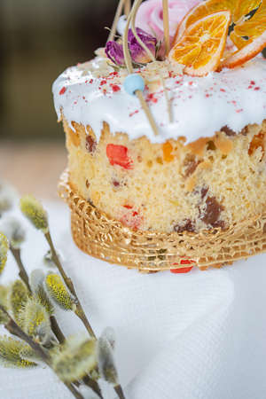 Close-up of an Easter cake. Dried oranges and roses on top of the cake.