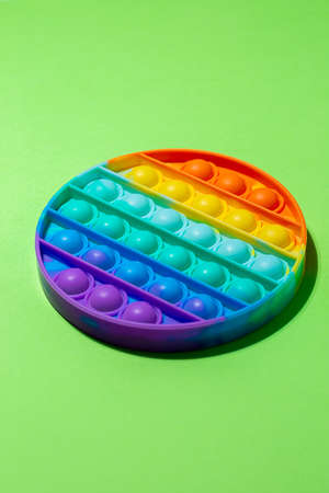 Top view of the Silicone sensory toy pop it on light green background with copy space for text. Antistress toy for children and adult.の写真素材