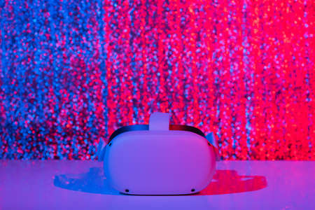 Virtual reality helmet on white background in neon light. VR, future, gadgets, technology concept.