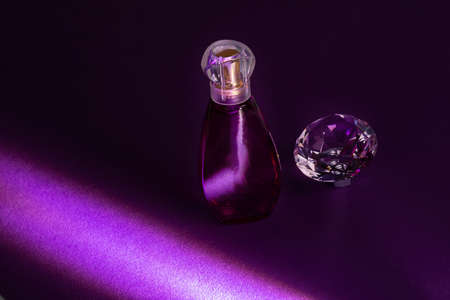 Perfume bottles studio shot on colored background with reflectionの写真素材