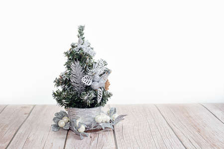 Cute little Christmas tree on wooden table on white backgroundの写真素材