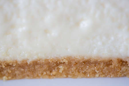 close-up of strawberry cheesecake on a white plate on a cake stand on a white backgroundの写真素材