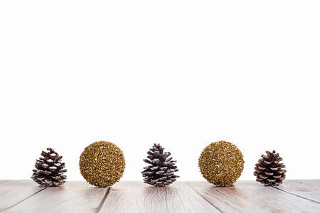 Christmas balls and pine cones on white background on wooden table. Holiday decoration