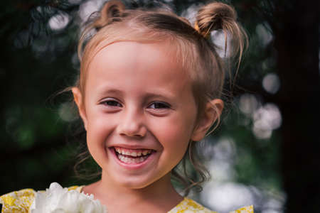 The caucasian child of 6 years is a beautiful girl with wide eyes, look at the camera. Expressive facial emotionsの写真素材