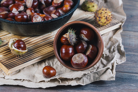 Edible chestnut kernels in a ceramic deep plate on a paper backing.