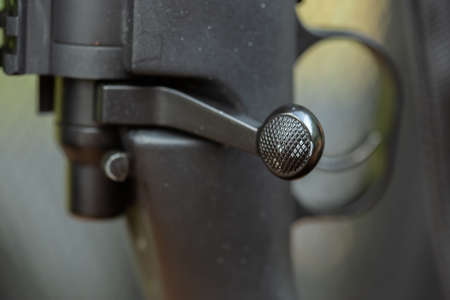 Close-up of parts of automatic weapon with selective focus and blurred background