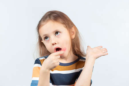 Adorable little girl puts myofunctional trainer in the mouth. dental tariner is made to help equalize the growing teeth and correct bite and Correct the position of the tongueの写真素材