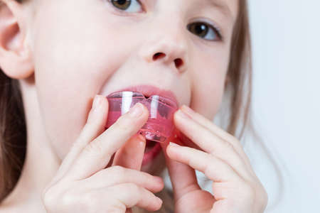 Adorable little girl puts myofunctional trainer in the mouth. dental tariner is made to help...