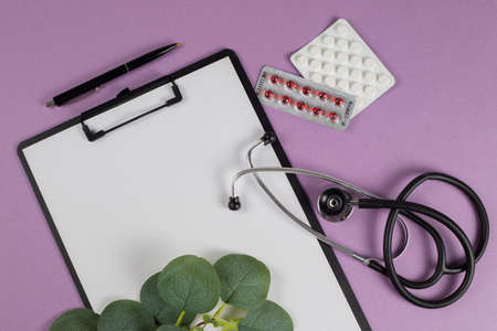 Treatment plan for a patient, doctor's desk top view. Stethoscope, note pad, medical conceptの写真素材
