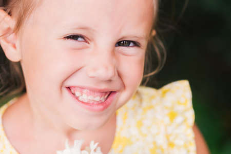 The caucasian child of 6 years is a beautiful girl with wide eyes, look at the camera. Expressive facial emotionsの写真素材