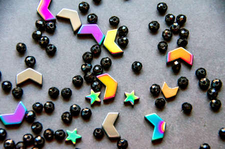 Colorful, black beads and stones isolated on white and grey backgroundの写真素材